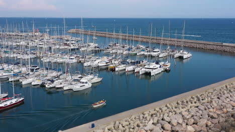 Boat-getting-out-of-Palavas-les-Flots-harbour-aerial-shot-France